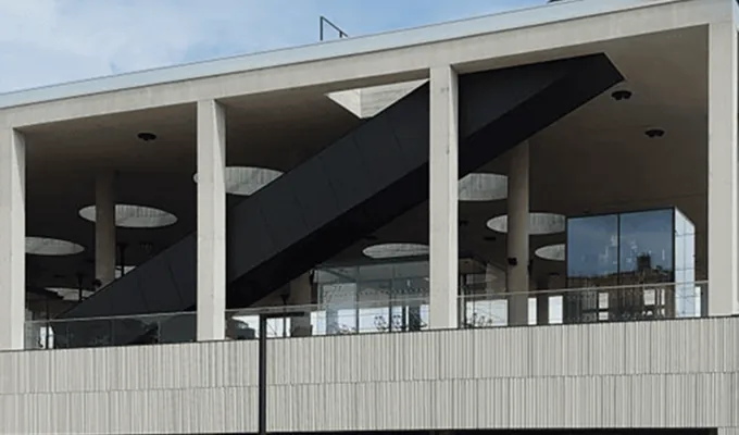 Railway station building with an open concrete concourse